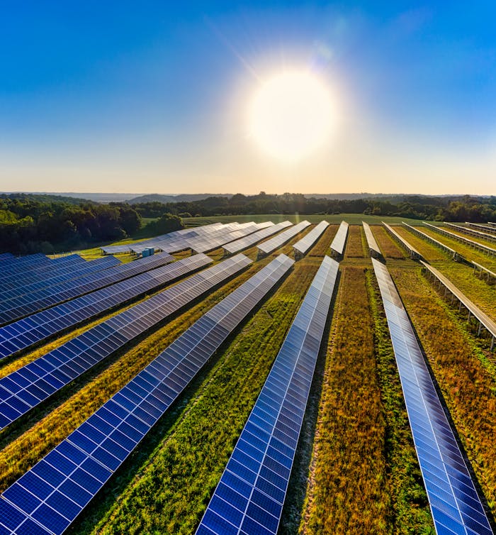 services-02 Aerial view of a solar farm in Red Wing, MN, with solar panels harnessing the sun's energy.